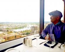 Stuart Wells sits at a table overlooking the Columbia River in Portland, OR